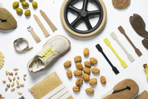 Auf weissem Untergrund liegen sauber ausgelegt Baumnüsse, Schuhe, ein Rad oder Hülsenfrüchte.