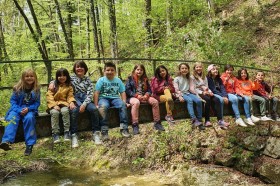 Bild Ferienhort Kinder sitzen in einer Reihe auf einer Brücke im Wald Bild Ferienhort Kinder sitzen in einer Reihe auf einer Brücke im Wald