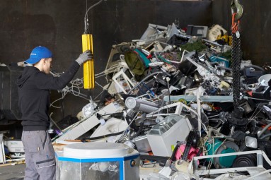 Ein Mann manövriert diverse Recyclingware.