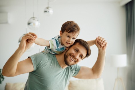 Happy father having fun while playing with his small son at home. Happy father having fun while playing with his small son at home.