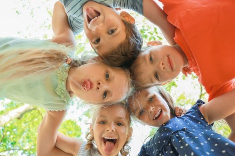 Group of children standing in circle, outdoors