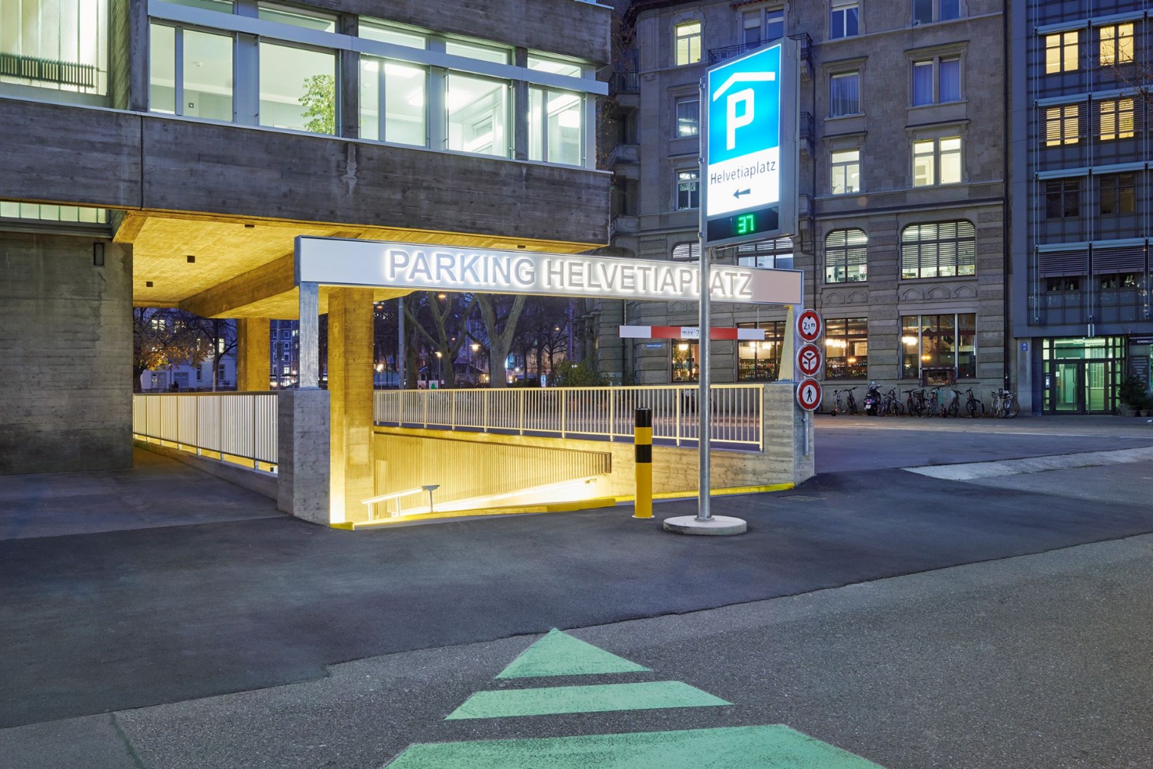 Erleuchteter Eingang zum Parkhaus mit blauer Anzeigetafel. Bild: Luca Zanier
