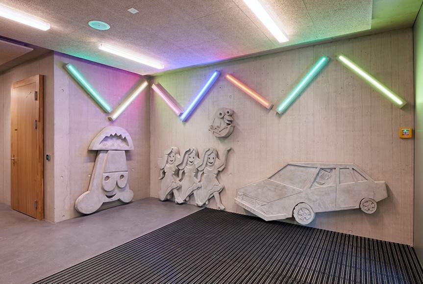 Betonfiguren und LED-Leuchten auf Wand